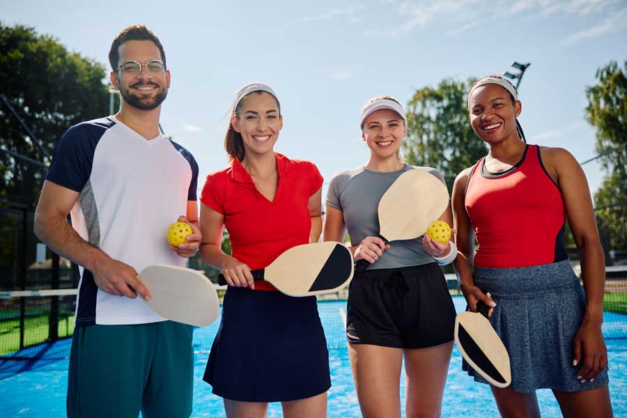 4 people playing pickleball