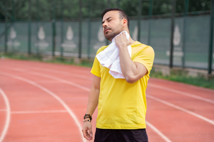 man wiping sweat